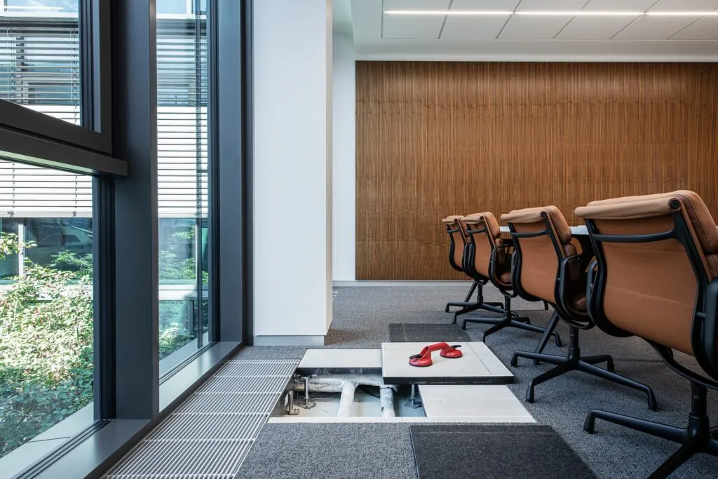 Opened Raised Floor in a meeting room showing concealed service routing beneath the floor panels.